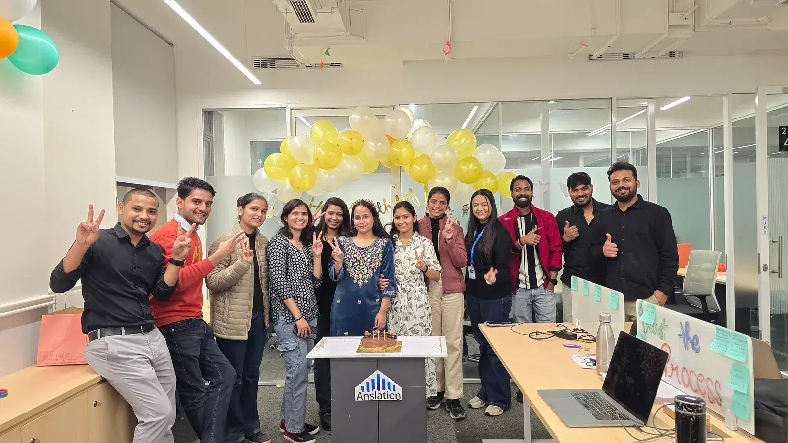 The ANSI team gathered around a birthday cake