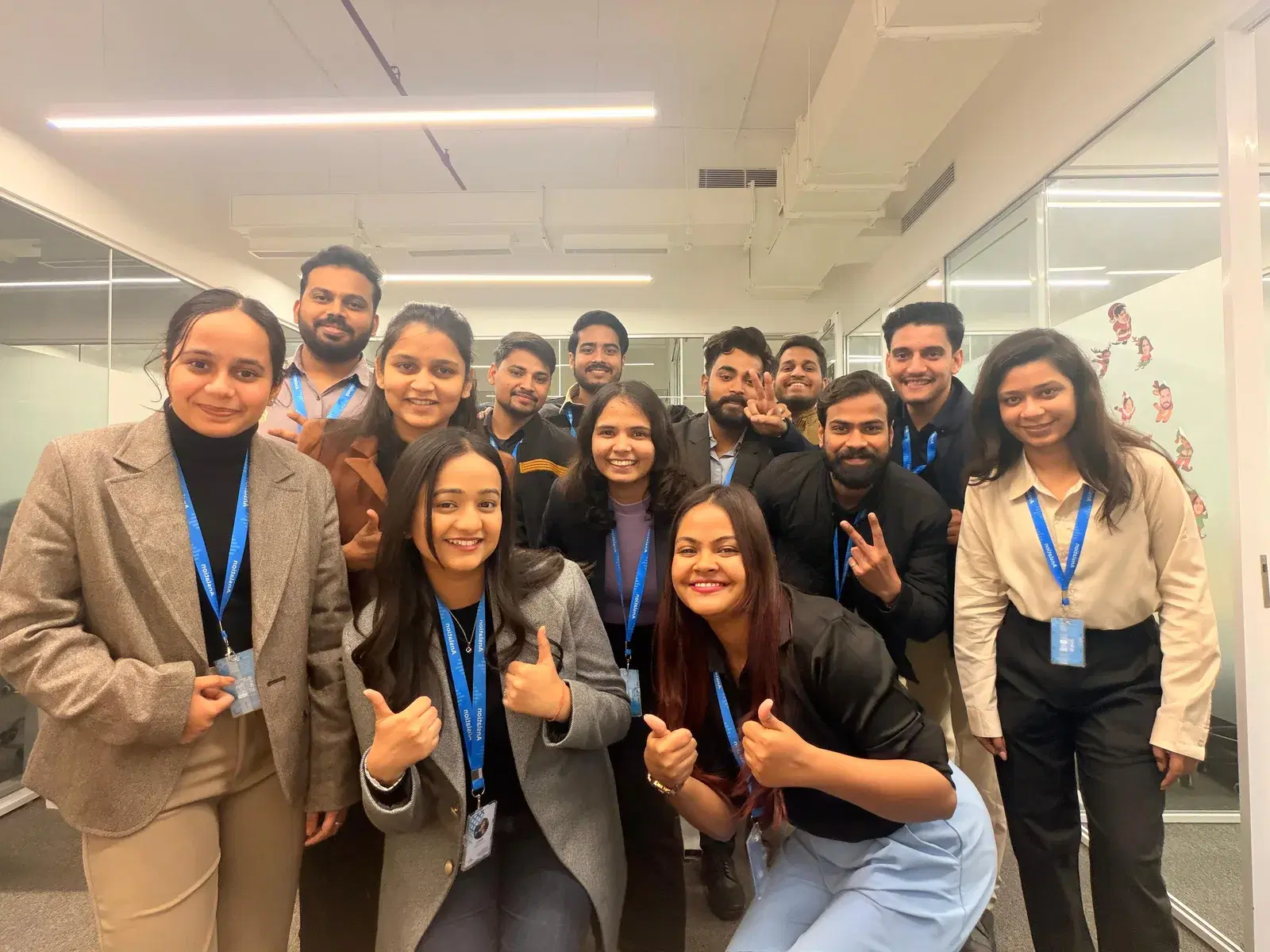 A large group of colleagues crowded together in the office